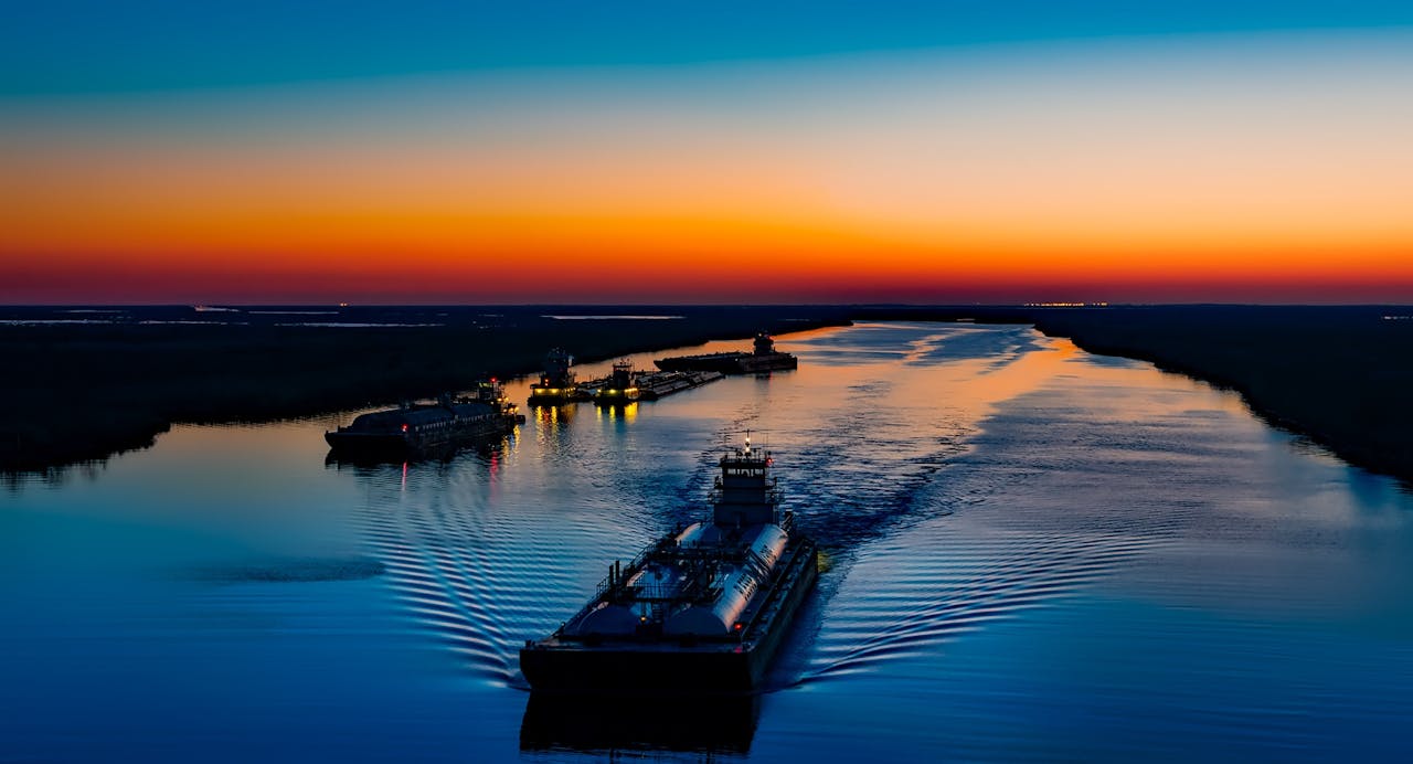 Serene twilight view of boats on the river in Port Arthur, Texas, USA.